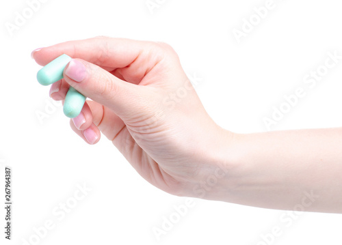 Green ear plugs in hand on white background isolation