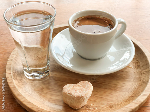 Fototapeta Naklejka Na Ścianę i Meble -  Turkish coffee and water served with a cookie