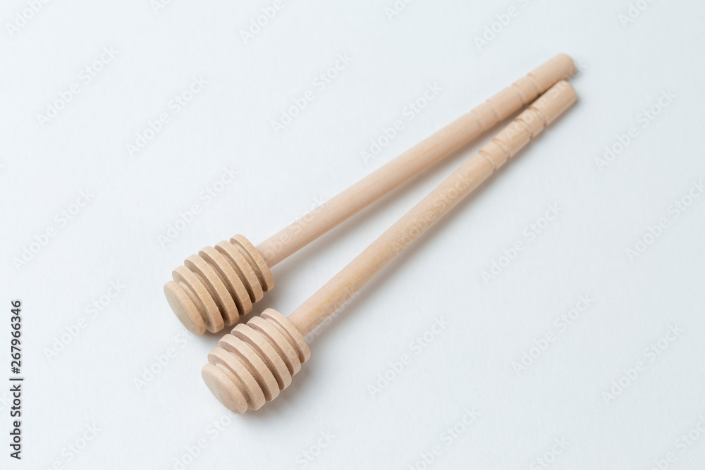 Wooden sticks for honey on a white background Wooden sticks for honey on a white background