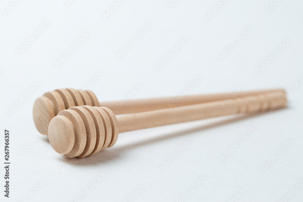 Wooden sticks for honey on a white background