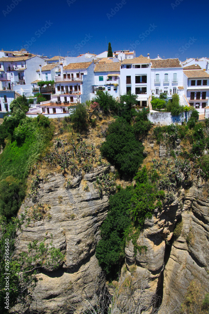 View on ancient village Ronda located precariously close to the edge of a cliff in Andalusia, Spain View on ancient village Ronda located precariously close to the edge of a cliff in Andalusia, Spain
