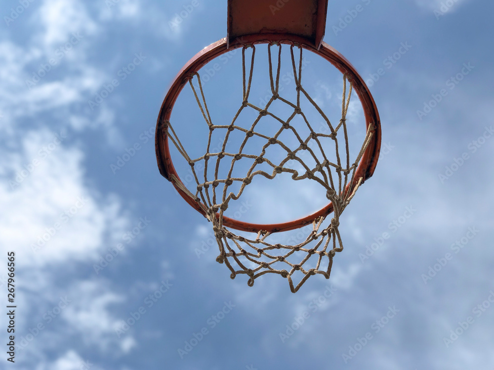 Basketball hoop against blue sky in a sunny day Basketball hoop against blue sky in a sunny day