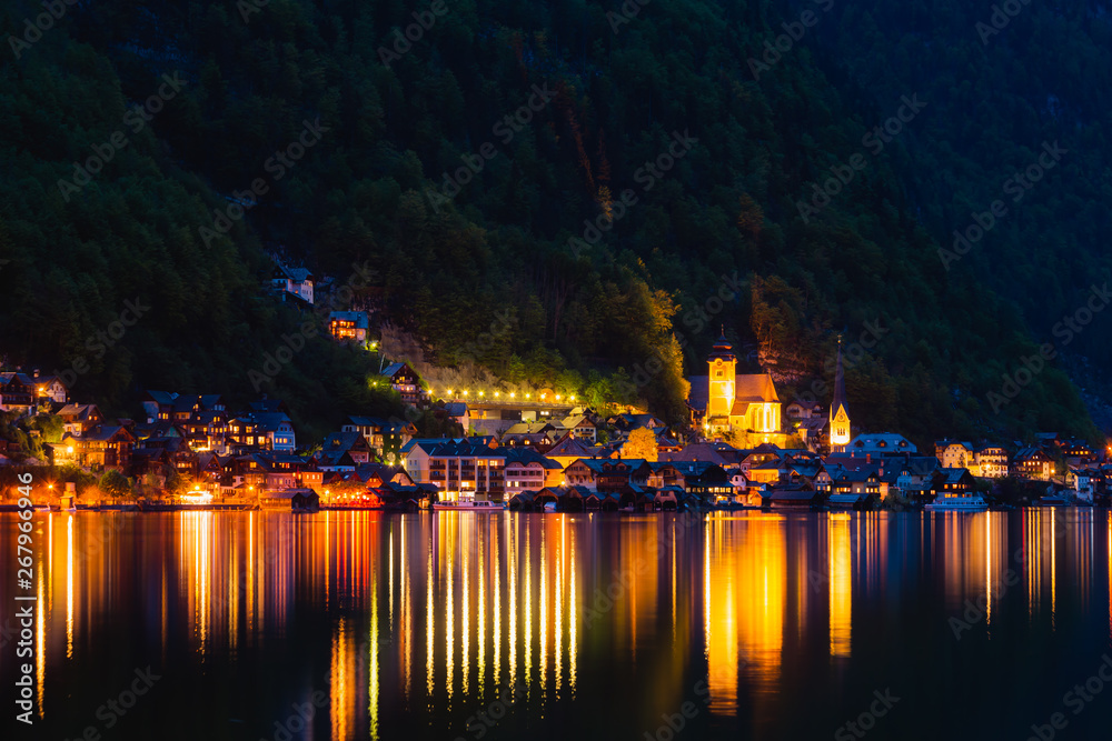 Hallstatt evening panorama. View on Hallstatt from lake with reflections on water