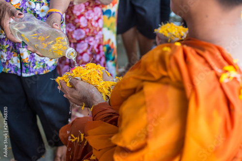 water pouring to monk in Songkran festival tradition of thailand photo