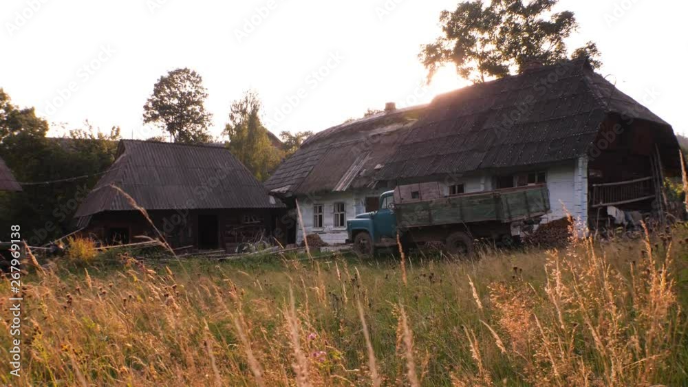 Summer rural scene. Old village house and stable and lorry car, evening in the village, Traditional Ukrainian village in summer, Old rural country wooden house in village. Far from megapolis. Summer rural scene. Old village house and stable and lorry car, evening in the village, Traditional Ukrainian village in summer, Old rural country wooden house in village. Far from megapolis.