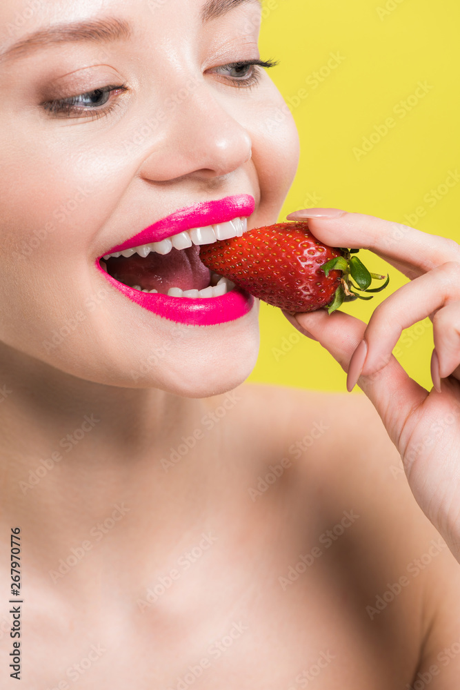 happy naked woman eating tasty strawberry isolated on yellow happy naked woman eating tasty strawberry isolated on yellow