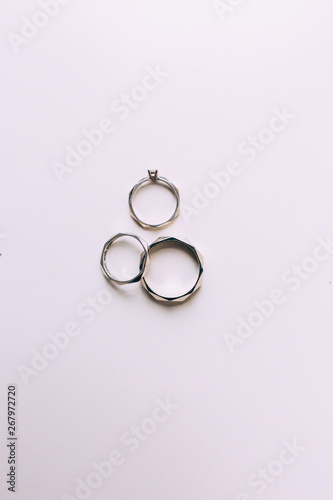 Silver rings of newlyweds with inscriptions on a white background.