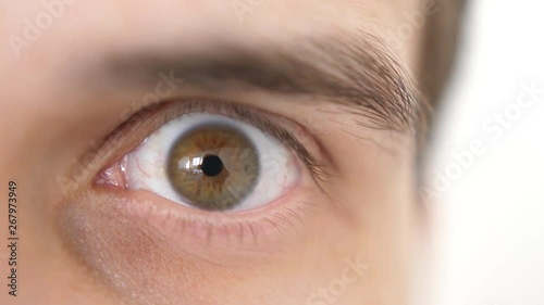 Close-up of a surprised emotional man with brown eye looking into the camera. 3840x2160