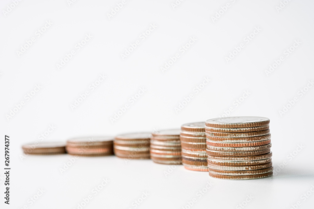 Closeup growing coins stacking on white background. Saving investment and profit concept.-Image. Closeup growing coins stacking on white background. Saving investment and profit concept.-Image.