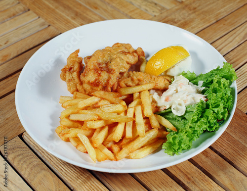 Fish and chips with french fries and vegetables