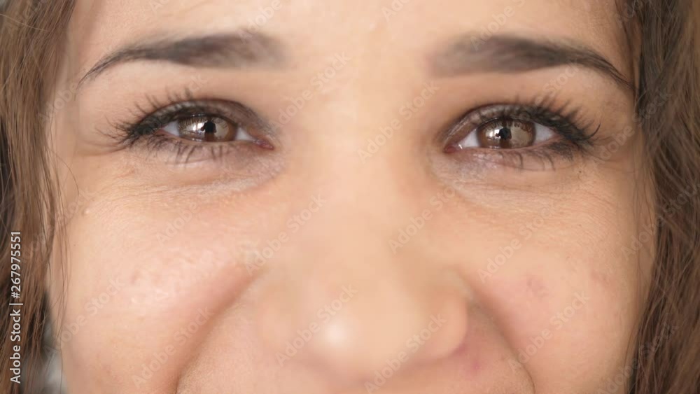 Close up portrait of beauty young woman's eyes, smiling looking at camera. slow motion. 3840x2160 Close up portrait of beauty young woman's eyes, smiling looking at camera. slow motion. 3840x2160