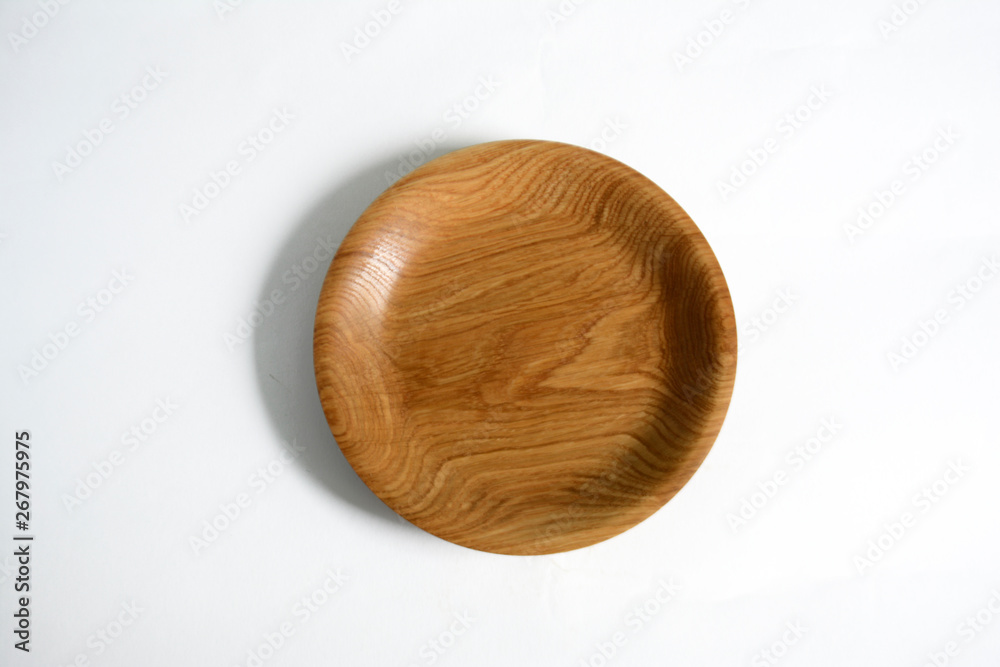 Empty wooden plate on light background Empty wooden plate on light background
