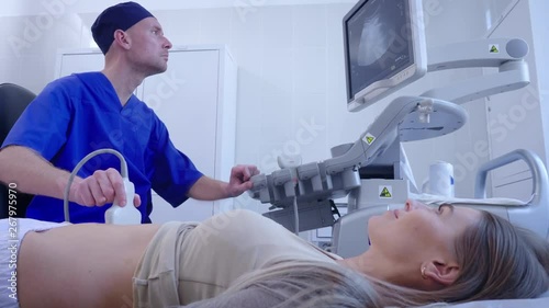Doctor makes an ultrasound examination of a beautiful woman