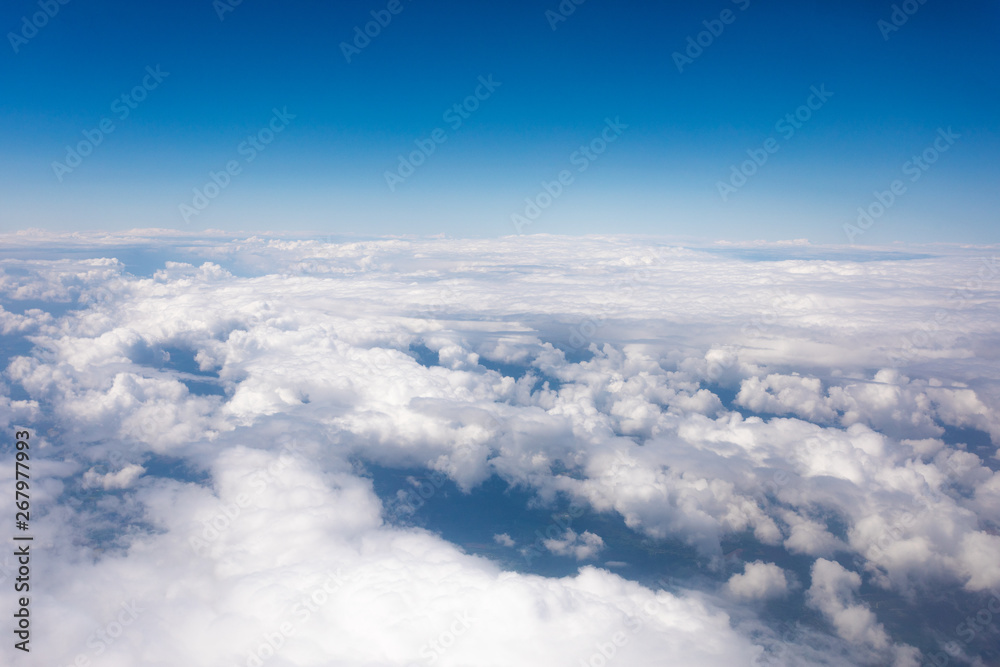 Earth in the airplane window with clouds