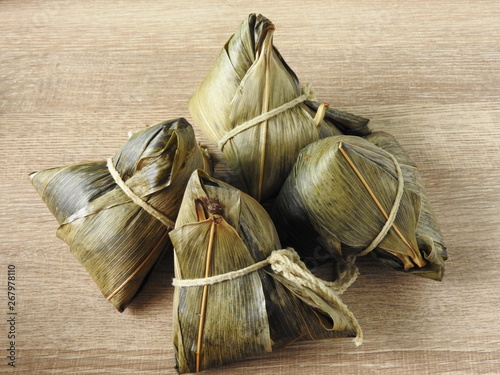 High angle view of zongzi also called rice dumplings or sticky rice dumplings on wooden background. Dragon boat festival is a traditional festival of East Asian culture. With copy space.