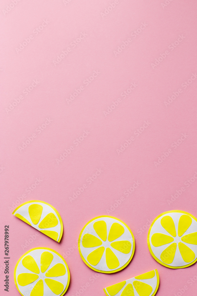 Slices of lemon on a pink background of paper, handmade