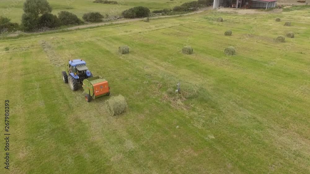 22bird eye of Man at work on the tractor with hay baler 22bird eye of Man at work on the tractor with hay baler