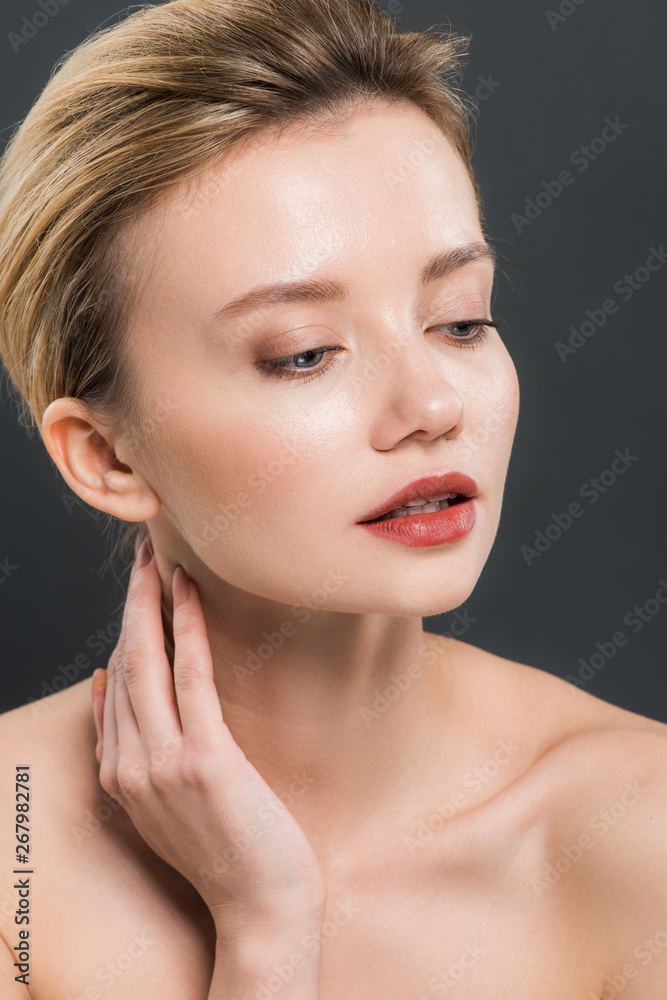 attractive young naked woman touching neck isolated on black attractive young naked woman touching neck isolated on black