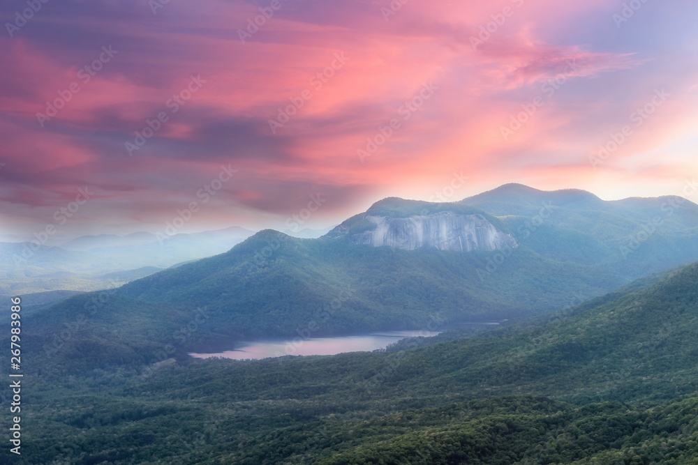 Soft, dreamy sunset view from a Caesars head overlook in South Carolina on a Table rock mountain and reflections in a lake