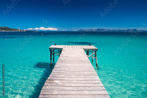 Pier on beautiful summer tropical beach. Holidays concept photo
