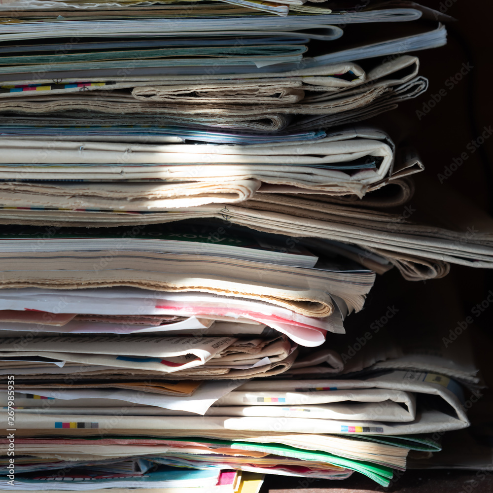 Pile of old newspapers and magazines, stack, side view. Vintage background Pile of old newspapers and magazines, stack, side view. Vintage background