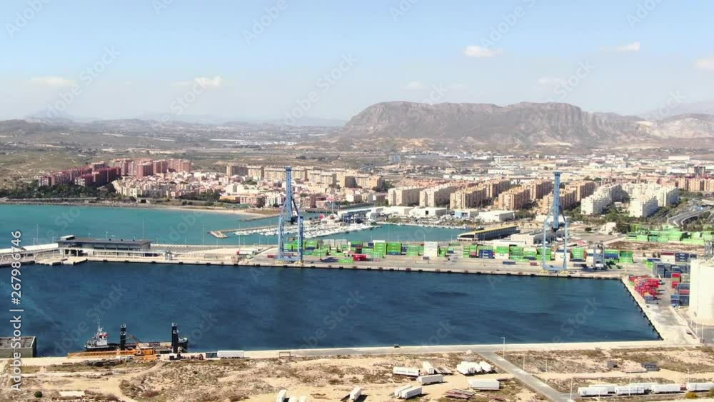 Aerial fast shot of the port of Alicante with the city behind on a sunny day.