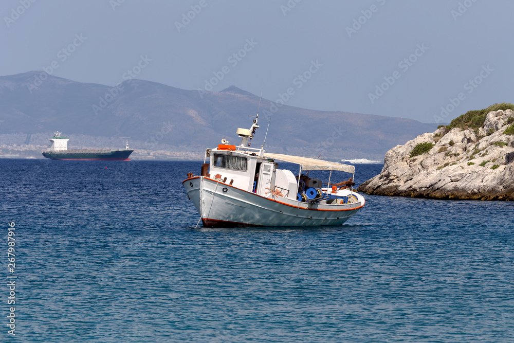 The fishing boat is moored in the open sea