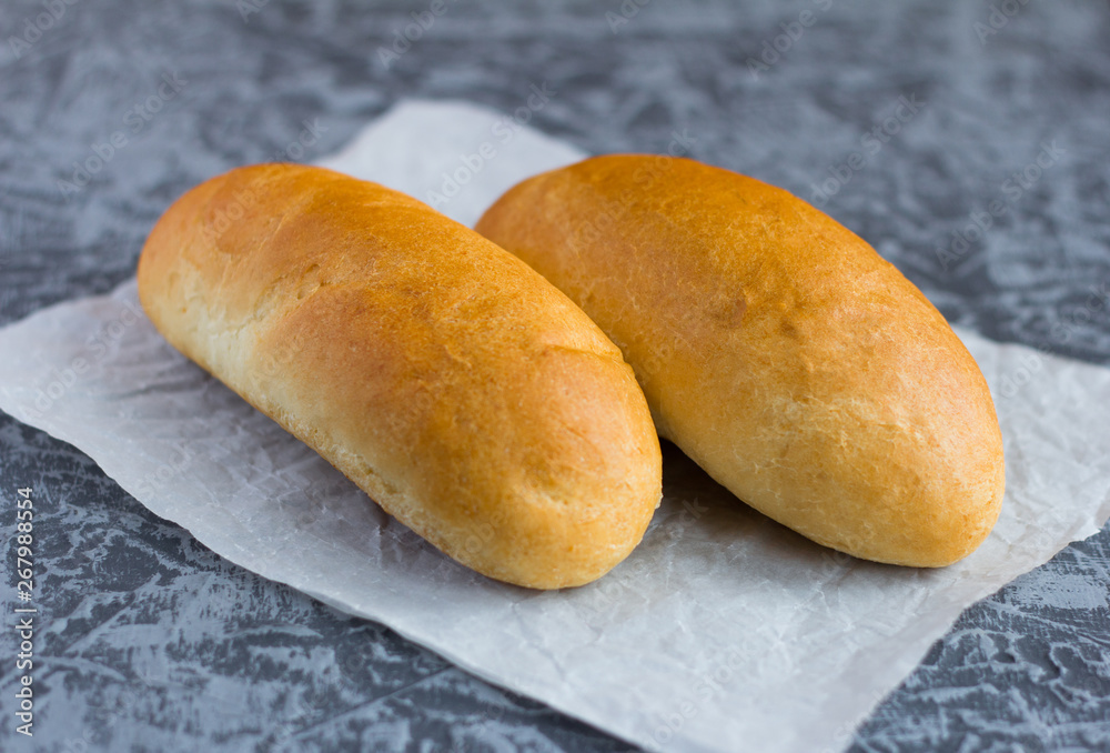 fresh crusty rolls for Breakfast on a grey background