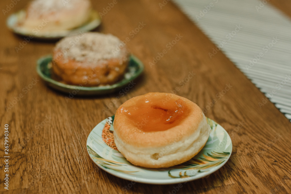 donuts without holes with a sprinkle and caramel top on the table. Delicious dessert.