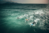 Triathlon swimmers train in open water