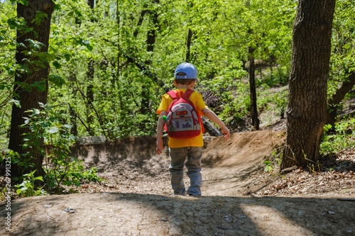 backpack child hiking summer green. cheerful.
