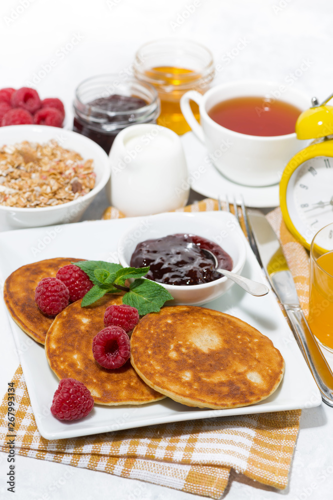 delicious pancakes with fresh raspberries and jam for breakfast, vertical delicious pancakes with fresh raspberries and jam for breakfast, vertical