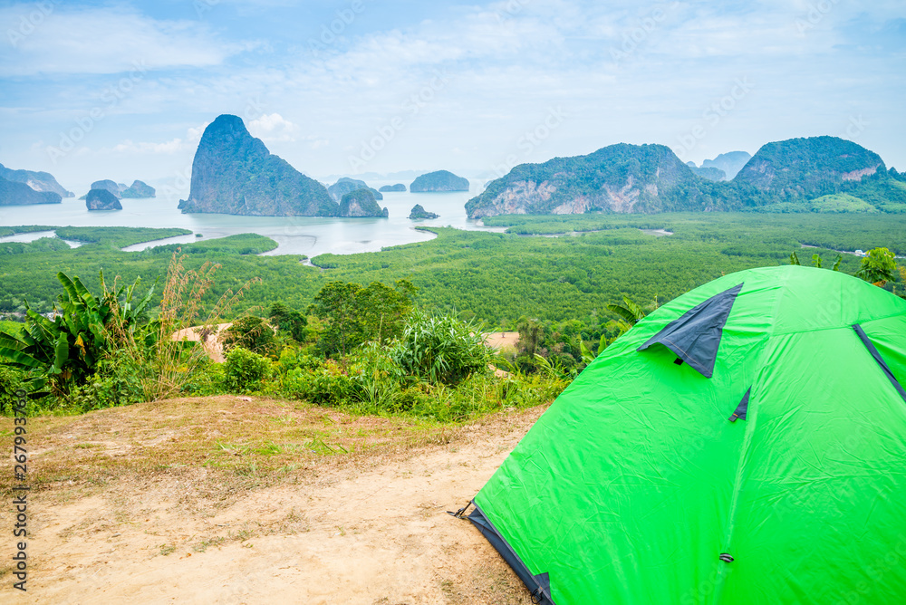 Camping tent on mountain with beautiful sea island view and forest seaside, Thailand. Summer tropical holiday vacation and lifestyle concept.