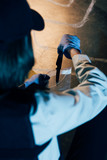 selective focus of investigator putting knife in ziploc bag at crime scene