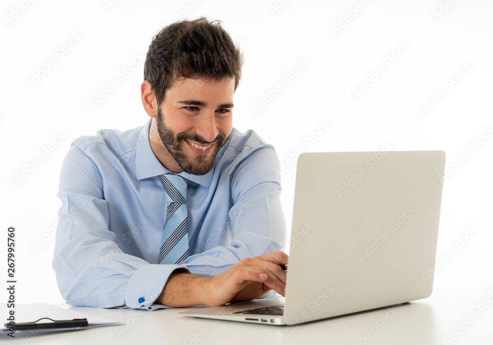 Attractive happy Young caucasian businessman working on laptop computer feeling successful at work Attractive happy Young caucasian businessman working on laptop computer feeling successful at work