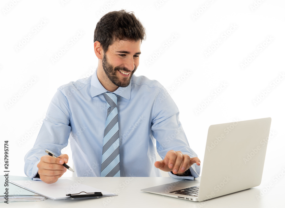 Attractive happy Young caucasian businessman working on laptop computer feeling successful at work Attractive happy Young caucasian businessman working on laptop computer feeling successful at work