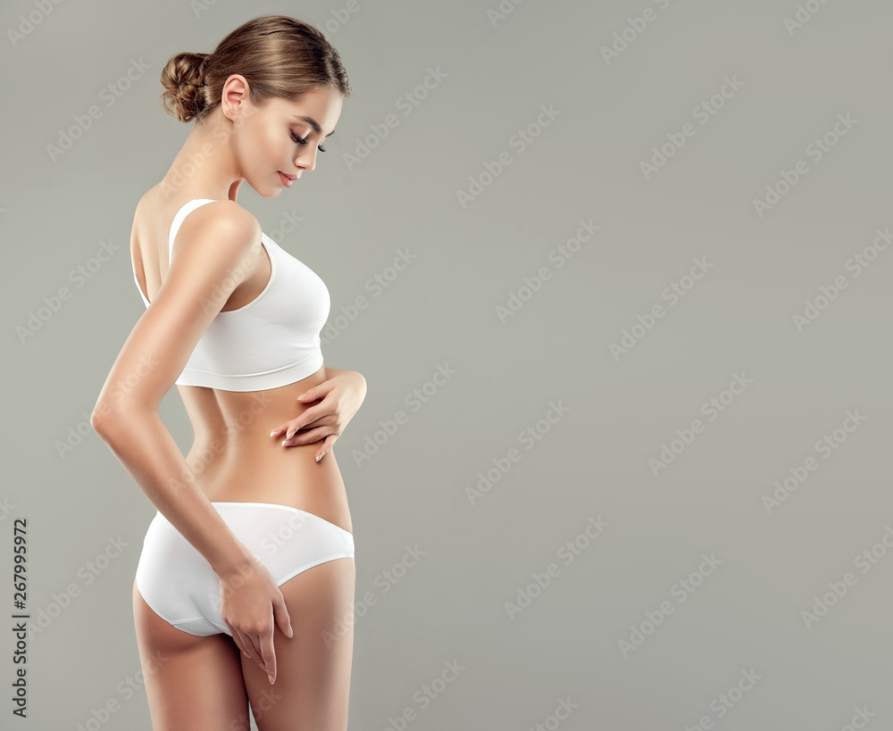 Perfect slim toned young body of the girl . An example of sports , fitness  or plastic surgery and aesthetic cosmetology. Stock Photo