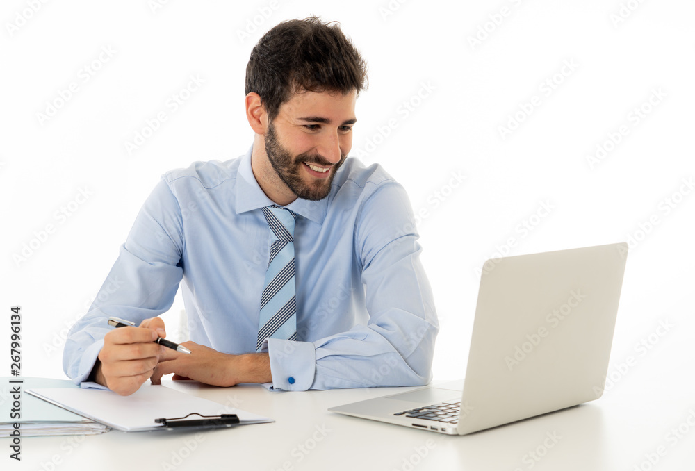 Attractive happy Young caucasian businessman working on laptop computer feeling successful at work Attractive happy Young caucasian businessman working on laptop computer feeling successful at work