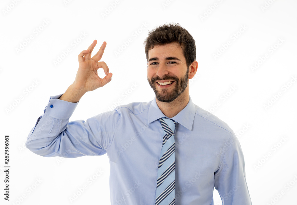 Portrait of young attractive businessman smiling and doing all OK sign Isolated on white background Portrait of young attractive businessman smiling and doing all OK sign Isolated on white background