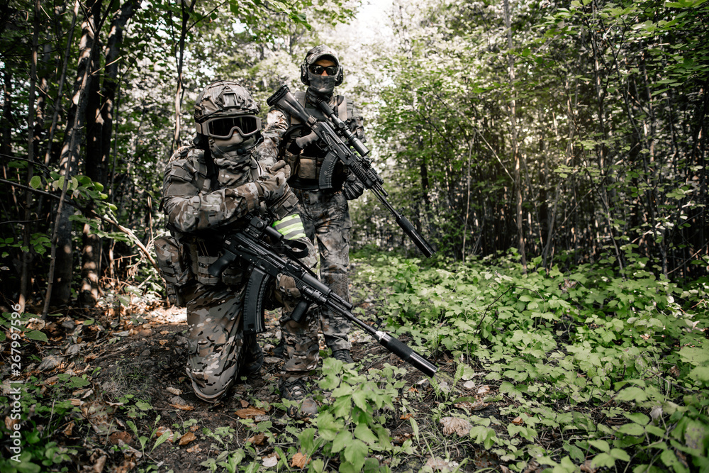 Armed intelligence of the United States of America are in the woods scouting the situation