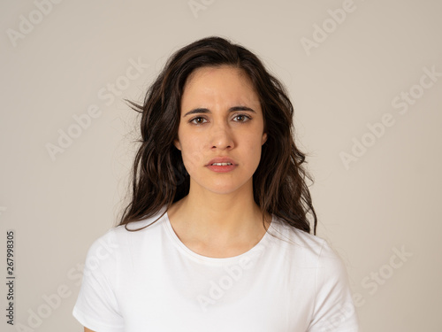 Portrait of beautiful young latin woman with angry and furious face. Human expressions and emotions