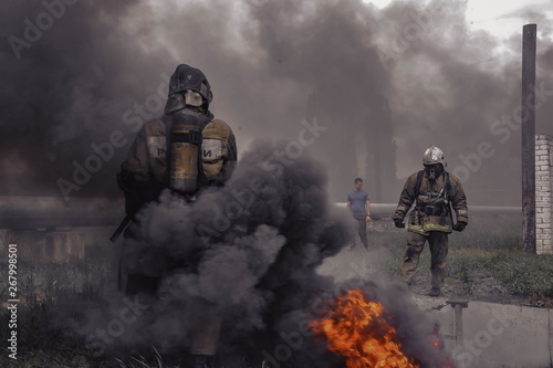 ordinary firefighter in a smoke-filled environment, moving in on the firing line