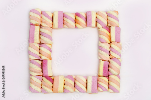 Square Frame from sweet Marshmallows on lignt background with copy space. photo