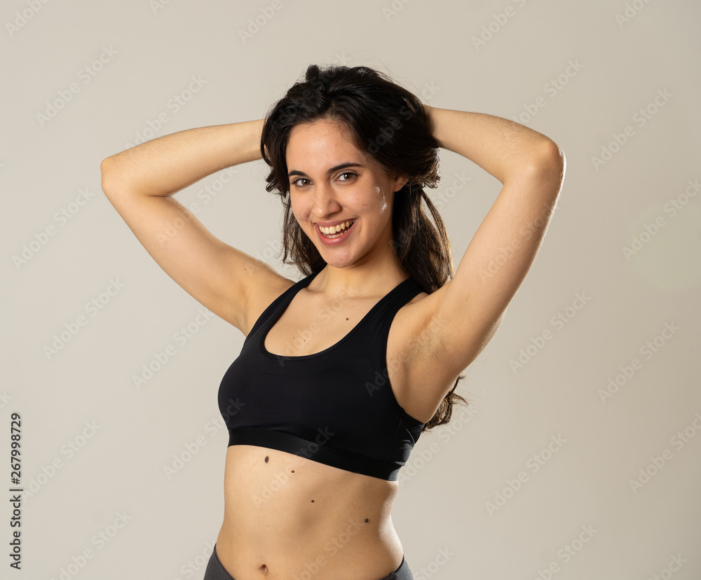 Obraz premium Portrait of sporty beautiful brunette woman in sport clothes looking sensual and fit