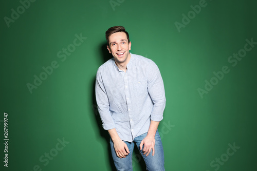 Portrait of handsome man posing on color background