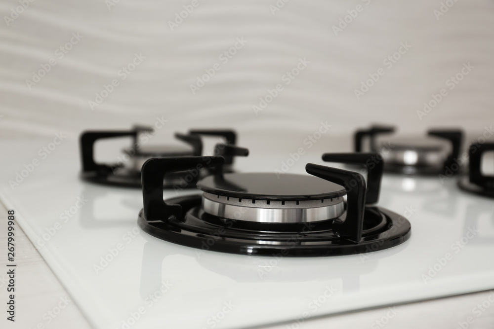 Modern built-in gas cooktop, closeup. Kitchen appliance Modern built-in gas cooktop, closeup. Kitchen appliance