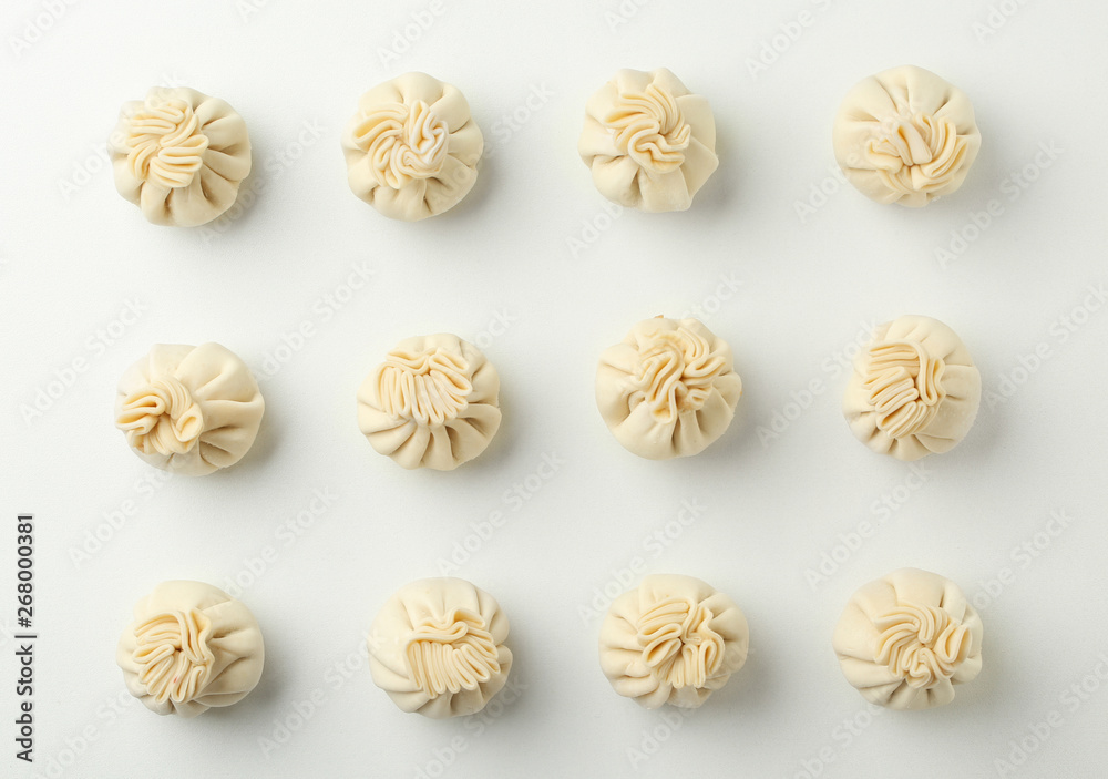 Composition with raw dumplings on white background, top view Composition with raw dumplings on white background, top view