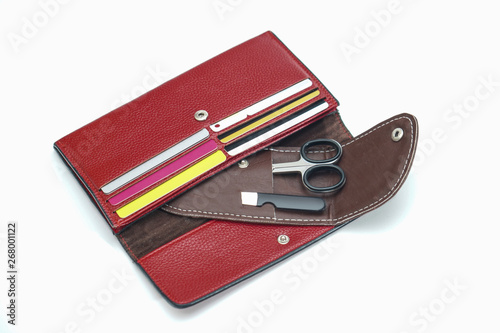 Manicure scissors in a leather brown case. Cosmetic bag, wallet pedicure accessories. Fashionable beauty theme. Stock photo