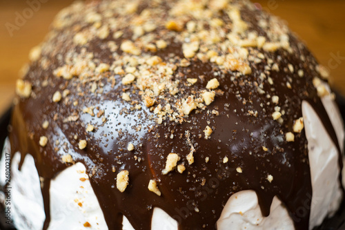 Close-up, delicious and appetizing souffle cake with chocolate sprinkled with nuts