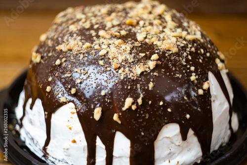 Close up, delicious and appetizing souffle cake with chocolate sprinkled with nuts